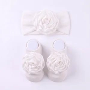 Set fascia e calzini da neonata con fiore bianco, dettagli accessori per capelli.