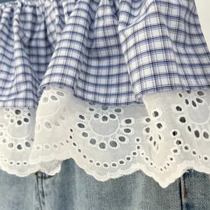 Blue white plaid layered skirt detail view, sweet white lace trim and denim fabric material.