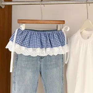 Detail view of Korean style plaid lace layering skirt with cute white bows and decorative trims.