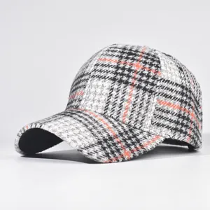 Detailed view of classic plaid baseball cap, autumn winter woolen texture, structured crown.