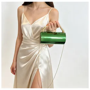Elegante groene metalen cilindrische avondtas met gouden handvat en ketting voor dames.