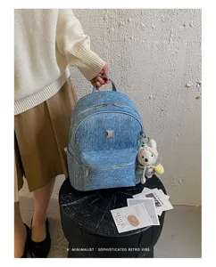 Blue denim backpack with sparkly details and cute bear pendant for women and students daily use.