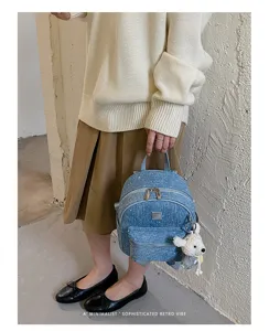 Denim mini backpack with cute bear pendant, casual travel daypack for women and students.