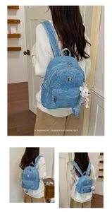 Stylish women's denim backpack with cute bear pendant, casual lightweight travel school bag.