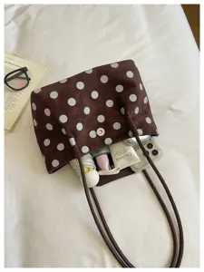 Detailed view of the brown polka dot tote bag showing its spacious interior and soft fabric texture.