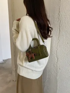 Modieuze groene geweven cilinder kussentas PU leer crossbody handtas met paard hanger
