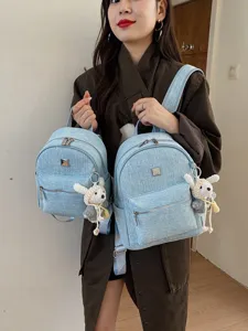 Lightweight denim backpack with sparkling details and cute plush pendant, casual travel student bag.