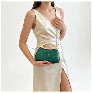 Green sequin evening clutch bag detail showing gold metal handle and chain strap.