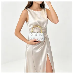 Metallic hard shell evening clutch featuring gold bamboo handle and silver chain strap.