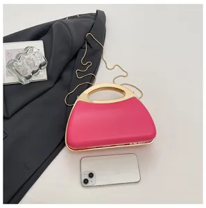 Pink hard shell evening clutch bag with metal handle and chain strap for women stylish detail.