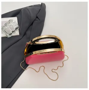 Acrylic evening clutch bag detail, chic gold metal handle and chain strap for women.