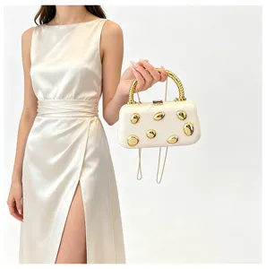 Elegant metal handle evening clutch hard shell box bag with gold studs and chain strap.