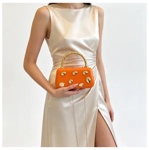 Orange hard shell clutch bag with gold pebbles and chain strap, elegant evening party accessory