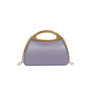 Detail view of purple acrylic hard-shell evening bag with gold metal handle and chain.