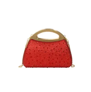 Red rhinestone evening clutch bag with gold metal handle and chain strap for party.