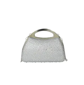 Detail view of a sparkling rhinestone evening clutch with silver metallic handle and chain.