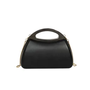 Exquisite black acrylic evening bag detail, featuring sleek metallic handle and fine chain.