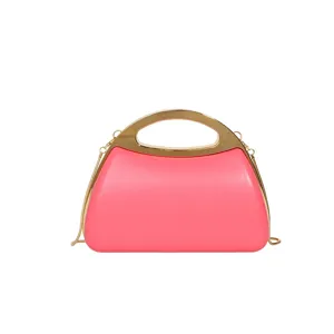 Stylish pink acrylic evening bag with gold metal top handle and chain strap for women.