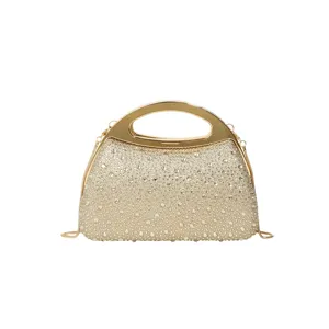 Gold rhinestone evening bag with metal handle and chain strap for luxury party dress.