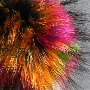 Fluffy colorful raccoon fur pom pom for winter knit hats, soft and vibrant fluffy ball accessory.
