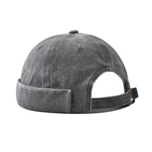 Detail view of the retro washed denim docker cap showing adjustable metal strap and brim.
