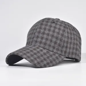 Close-up detail showing the fabric texture and pattern of the classic plaid wool cap.