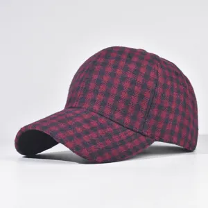 Detailed view of the red and black plaid baseball cap, showcasing cozy woolen fabric texture.