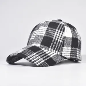 Black and white plaid baseball cap detail view showing fabric texture and hard top design.