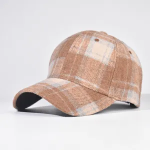 Detail view of the brown plaid wool baseball cap showing fine fabric texture and structured crown.