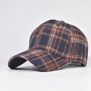 Detail shot of the stylish plaid baseball cap showing the textured fabric and hard crown structure.