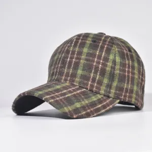 Close-up detail of the green and brown plaid baseball cap, autumn and winter style design.