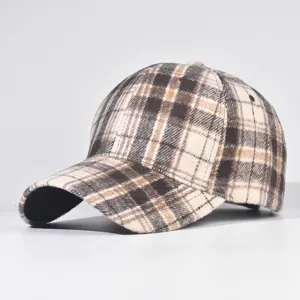 Detailed shot of winter plaid baseball cap, brown and cream check pattern, close-up.
