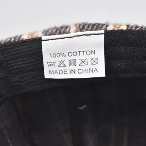 Detailed inner washing label view showing 100% cotton material inside the plaid cap.