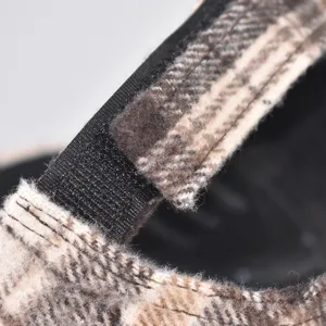Detailed view of the winter plaid baseball cap strap, showing soft fabric texture.