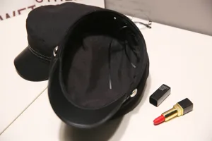 Detail shot of black newsboy cap interior lining and brim structure, women fashion hat.