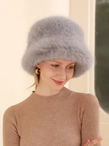 Detailed close-up view of a stylish grey plush winter bucket hat worn by a female model.