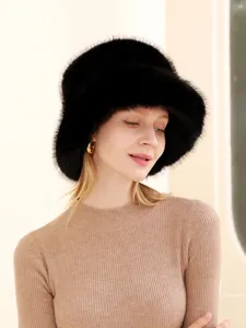 Close-up detail of luxurious black fox fur bucket hat, showing soft fluffy texture and warm design.