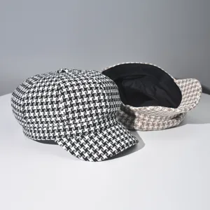 Classic houndstooth newsboy cap detail shot, showing retro style and black lining texture clearly.