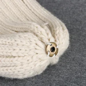Children ribbed knit beanie hat close up detail view, soft winter warm headwear off white.