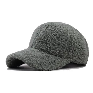 Close-up detail of the thick lamb wool baseball cap, soft fleece texture and warm grey color.