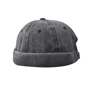 Washed denim dockers cap, vintage black roll cap, casual street style hat detail.
