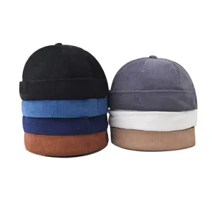 Corduroy docker cap detail shot, showing colorful brimless hip-hop hats in neat stacks.