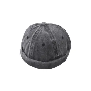 Washed denim brimless docker cap detail, retro street style melon hat close up view.