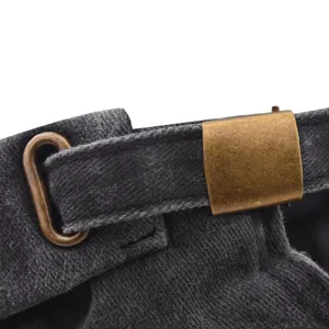 Close-up detail of the adjustable bronze metal buckle and washed denim strap on the docker cap.