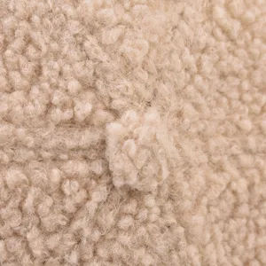 Close-up detail of thick teddy fleece winter hat texture, showing soft sherpa fabric material.