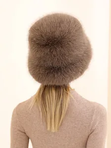 Detail view of a plush furry winter bucket hat in cozy brown, showing soft fluffy texture.
