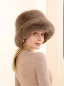 Detail view of a fluffy khaki brown fox fur bucket hat, winter warm plush headwear.
