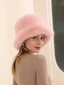 Pink furry bucket hat detail view, soft plush winter cap for women, cozy outdoor headwear.