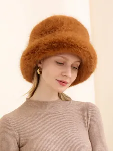 Close-up view of the fluffy faux fox fox fur bucket hat in caramel brown, winter warm fuzzy style.