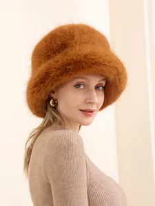 Detail shot of the fluffy fox fur bucket hat, showcasing soft texture and warm autumn style.